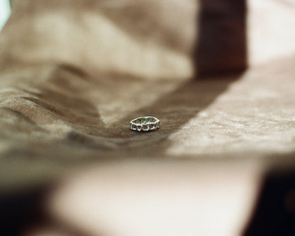 Silver ring on a textured surface with a blurred background