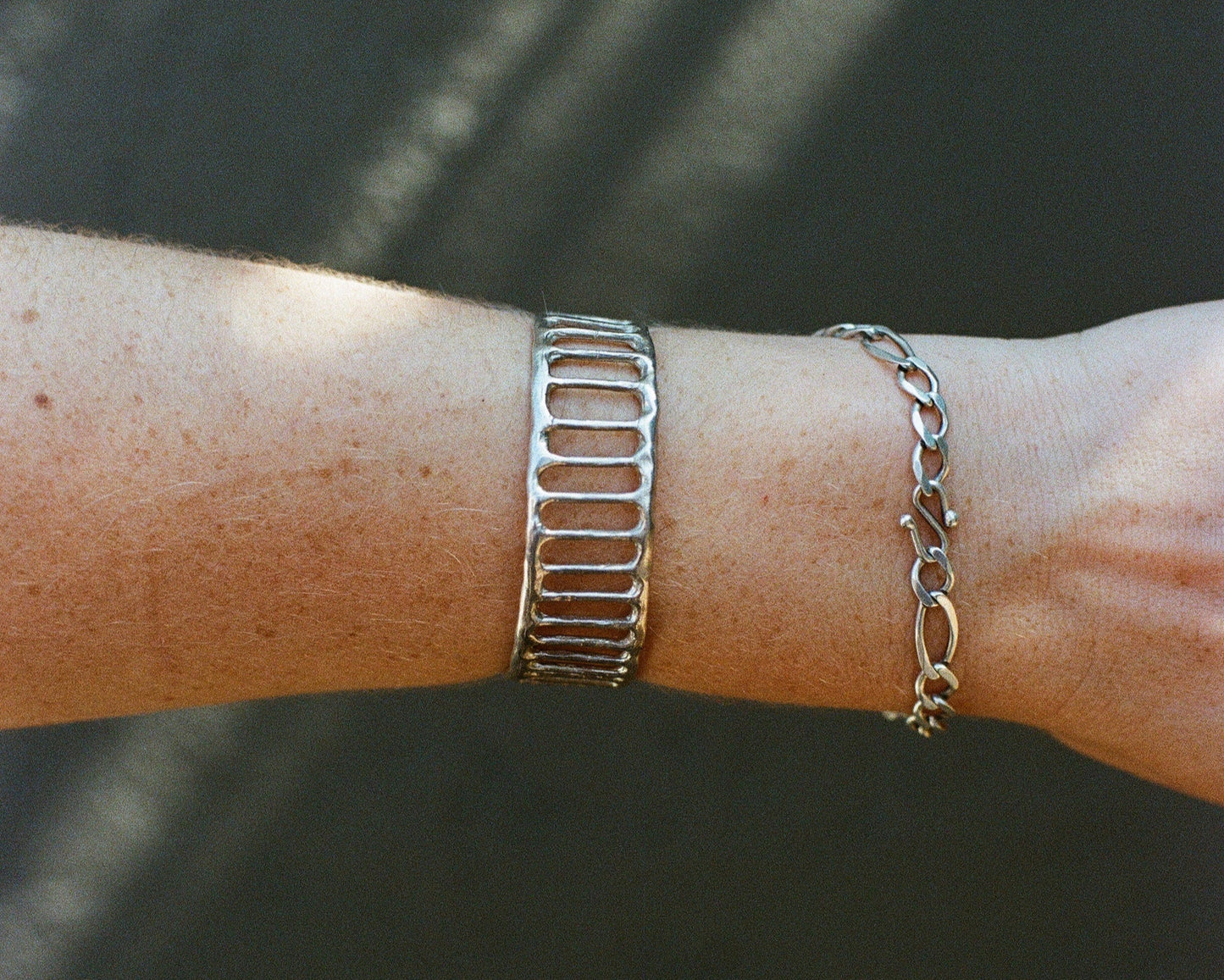 Silver bracelet on a wrist with a blurred background