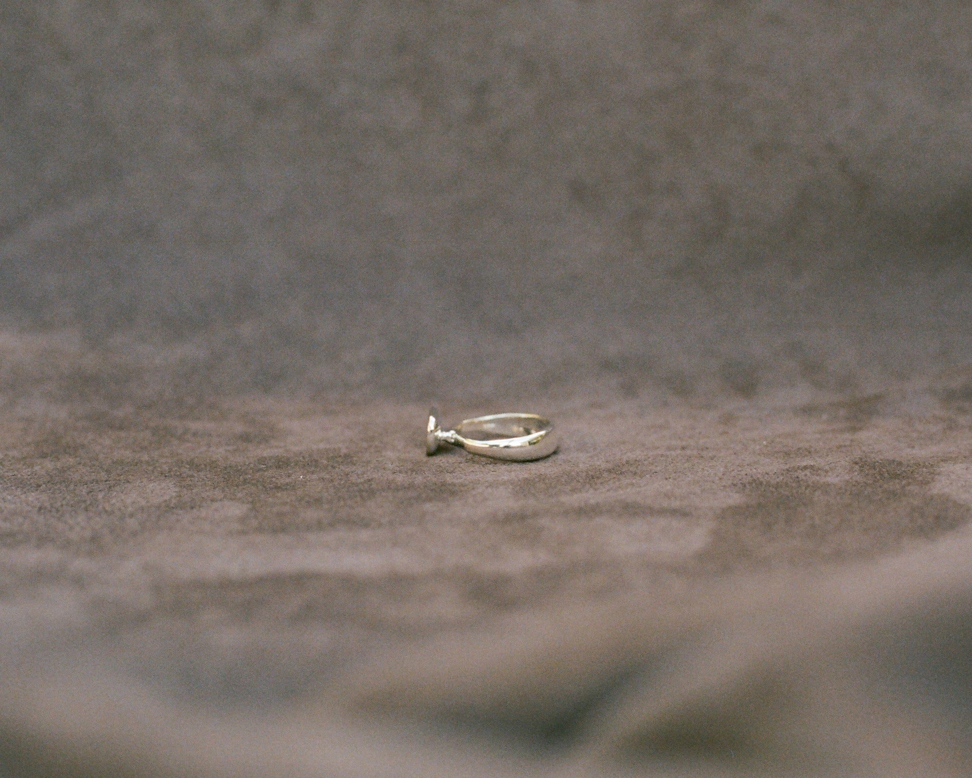 Silver ring on a textured gray surface