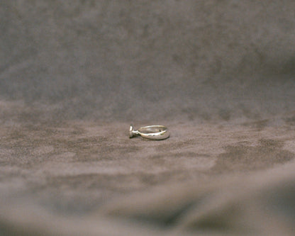 Silver ring on a textured gray surface