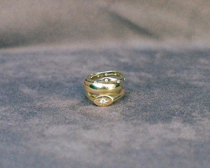 Three gold rings stacked on a textured background
