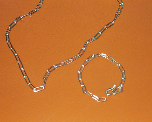 Sterling silver chain against an orange background
