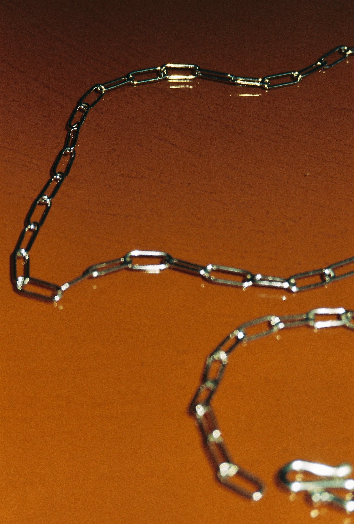 Metallic chain on a orange surface
