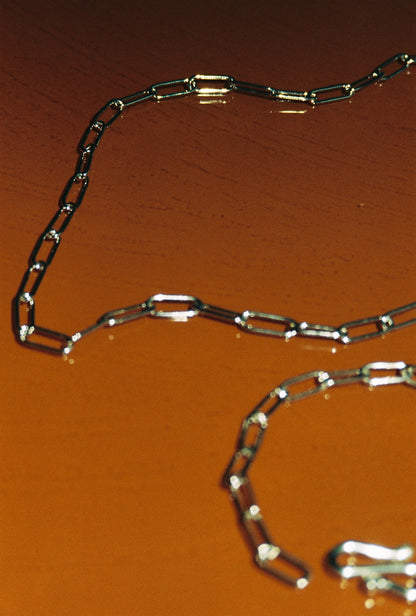 Metallic chain on a orange surface